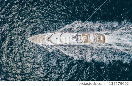 Summer sea vacation. Boat trip. Luxury lifestyle and traveling. Sea boat go to yacht marina. Yachting and boating marina. Yacht boat sailing. Top view. Aerial view luxury motorboat in sea 135579602