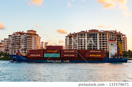 Miami, Florida, USA - April 07, 2025: Cargo Antillean Line ship services with container pass Fisher island, aerial. Freight container on cargo vessel. Cargo ship vessel. Miami port. Container ship Miami, Florida, USA - April 07, 2025: Cargo Antillean Line ship services with container pass Fisher island, aerial. Freight container on cargo vessel. Cargo ship vessel. Miami port. Container ship 135579671