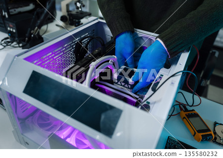 Hands repairing electronic devices. Electronic technician. Hands repairing electronic devices. Electronic technician. 135580232