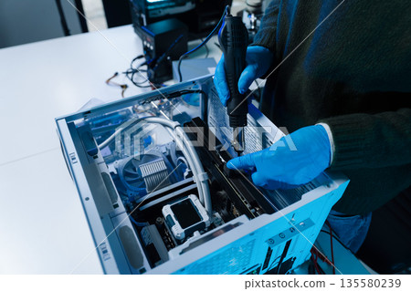 Hands repairing electronic devices. Electronic technician. Hands repairing electronic devices. Electronic technician. 135580239