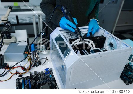 Hands repairing electronic devices. Electronic technician. Hands repairing electronic devices. Electronic technician. 135580240