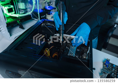 Hands repairing electronic devices. Electronic technician. Hands repairing electronic devices. Electronic technician. 135580259