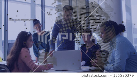 Collaborating business-casual team discussing ideas in glass conference room, laptop and documents 135580379