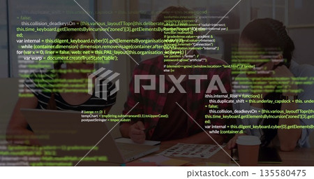 Reviewing software developers collaborating on code in meeting room, with laptop and code sheets Reviewing software developers collaborating on code in meeting room, with laptop and code sheets 135580475