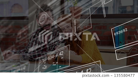 Typing man and woman reviewing project on laptop and smartphone at office table, with code overlays Typing man and woman reviewing project on laptop and smartphone at office table, with code overlays 135580477