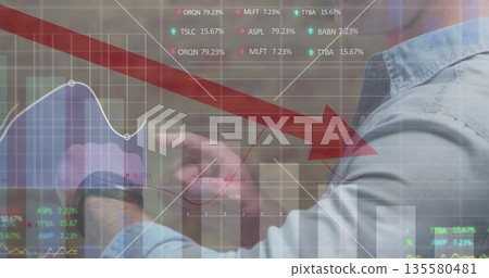 Pointing analyst interacting with financial charts with red arrow in office, copy space Pointing analyst interacting with financial charts with red arrow in office, copy space 135580481