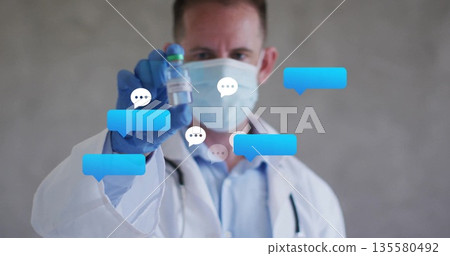 Presenting doctor wearing mask and gloves holding glass vial in clinic, with digital chat bubbles Presenting doctor wearing mask and gloves holding glass vial in clinic, with digital chat bubbles 135580492