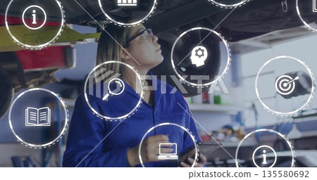 Technician inspecting plane belly in hangar wearing glasses using tablet with floating icons Technician inspecting plane belly in hangar wearing glasses using tablet with floating icons 135580692