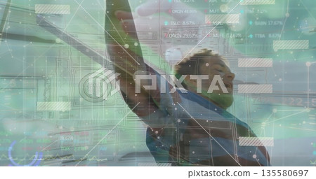 Balancing African-American athlete raising arms in gray jacket on coast, with floating UI charts Balancing African-American athlete raising arms in gray jacket on coast, with floating UI charts 135580697
