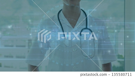 Standing female doctor monitoring digital interface inside clinic, with stethoscope and lab coat Standing female doctor monitoring digital interface inside clinic, with stethoscope and lab coat 135580711