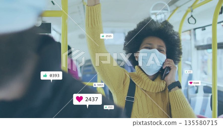 Talking woman wearing mask gripping handrail using phone on bus, social media icons, copy space 135580715