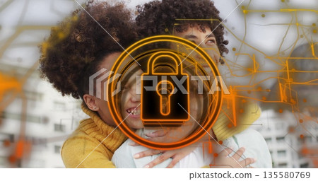 Embracing couple wearing white shirt and yellow sweater in loft, with orange padlock and circuits Embracing couple wearing white shirt and yellow sweater in loft, with orange padlock and circuits 135580769
