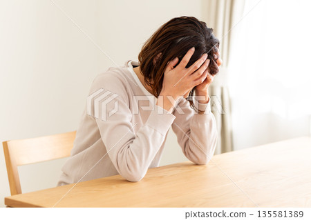 中年婦女在房間裡感到沮喪 中年婦女在房間裡感到沮喪 135581389
