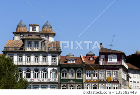 Colorful historic buildings in Guimaraes, Portugal, with traditional tiled roofs, decorative 135582449