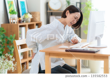 在客廳裡的中年女子遠程辦公 135582553