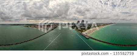 Panorama of Miami Beach skyline. Drone shot of Miami Beach cityscape. Top view of South Miami Beach and the ocean. Miami Beach skyline with skyscrapers and coastline from above. 135582759