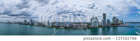 Aerial view of South Beach coastline. Miami skyline with tropical blue waters panorama. Panorama over the Miami skyscrapers. Miami, Florida waterfront cityscape. Iconic South Florida travel Aerial view of South Beach coastline. Miami skyline with tropical blue waters panorama. Panorama over the Miami skyscrapers. Miami, Florida waterfront cityscape. Iconic South Florida travel 135582766