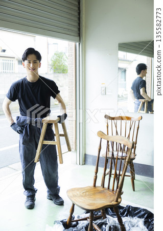 Man painting a chair Man painting a chair 135582773