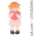 Smiling child girl hugging a heart 135582840