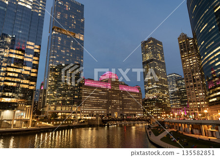 Chicago architecture of skyscraper at river. City night illuminated building. Skyscraper cityscape. Night city of Chicago, Illinois. Business city. Night cityscape of Chicago skyscraper building Chicago architecture of skyscraper at river. City night illuminated building. Skyscraper cityscape. Night city of Chicago, Illinois. Business city. Night cityscape of Chicago skyscraper building 135582851