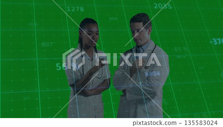 Two doctors in lab coats with stethoscopes gesturing and discussing data on green grid on screen Two doctors in lab coats with stethoscopes gesturing and discussing data on green grid on screen 135583024