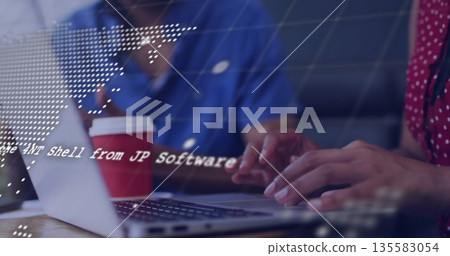 Collaborating software developers coding in office lounge, with laptop coffee cup and code overlay 135583054