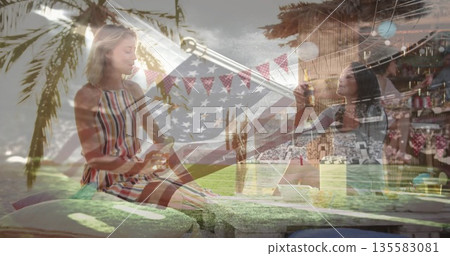 Sitting woman in sundress resting on cushions at patio under palm tree, pennant banners, copy space 135583081