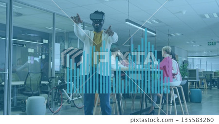 Gesturing man wearing white blazer and VR headset interacting in tech office, with controller 135583260