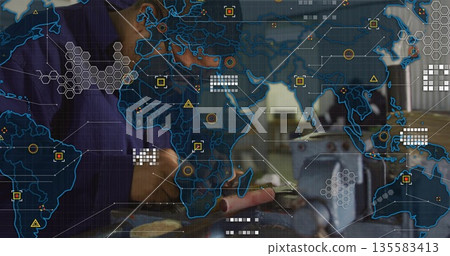 Gloved machinist in navy coveralls operating lathe with part in workshop, with digital map overlay Gloved machinist in navy coveralls operating lathe with part in workshop, with digital map overlay 135583413
