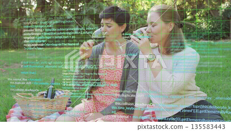 Friends wearing pink and white sampling food on checkered blanket in park, with bowls, code overlay Friends wearing pink and white sampling food on checkered blanket in park, with bowls, code overlay 135583443