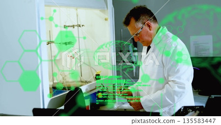 Scientist in lab coat and safety glasses examining vial at fume hood, checking overlays, copy space 135583447
