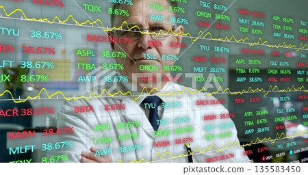 Observing senior financial analyst assessing market trends at trading room, with ticker display Observing senior financial analyst assessing market trends at trading room, with ticker display 135583450