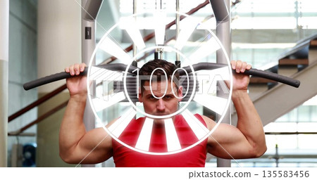 Performing lat pulldown, man in red top gripping wide bar handles at gym, with weight stack Performing lat pulldown, man in red top gripping wide bar handles at gym, with weight stack 135583456