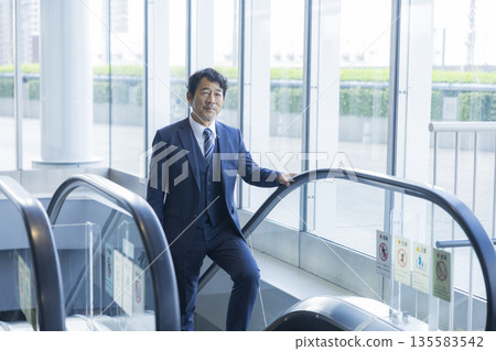 Escalator and businessman 135583542