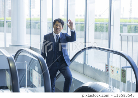 Escalator and businessman 135583543