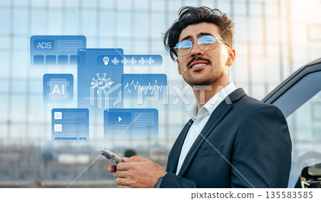 Man holding phone while looking at digital interface in city 135583585