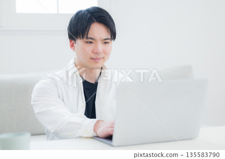 A young man who operates a computer A young man who operates a computer 135583790