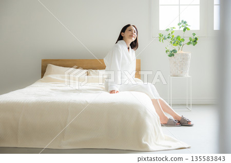 A woman relaxing at bed 135583843