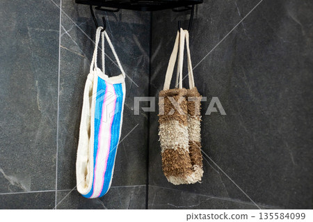 Intimate view highlighting textured materials of bath accessories in peaceful shower space Intimate view highlighting textured materials of bath accessories in peaceful shower space 135584099