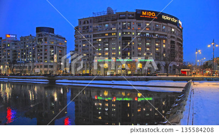 Bucharest, Romania - January 9, 2019: Winter nightscape in Bucharest. Modern buildings in Bucharest city, Romania. Bucharest, Romania - January 9, 2019: Winter nightscape in Bucharest. Modern buildings in Bucharest city, Romania. 135584208