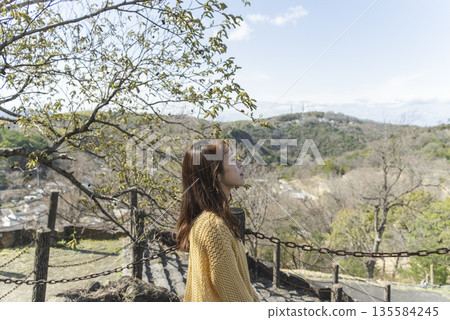 Woman relaxing in a beautiful park Woman relaxing in a beautiful park 135584245