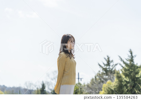 Woman relaxing in a beautiful park Woman relaxing in a beautiful park 135584263