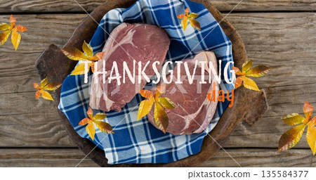Image of thanksgiving day text over autumn leaves and meet on wooden boards 135584377