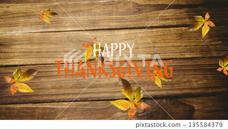 Image of happy thanksgiving text over autumn leaves on wooden boards Image of happy thanksgiving text over autumn leaves on wooden boards 135584379