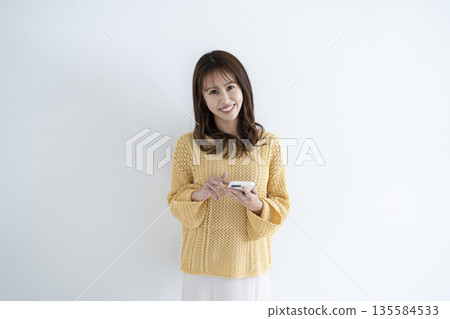 Woman using a smartphone Woman using a smartphone 135584533