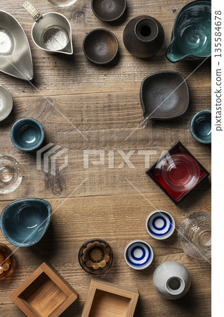 Copy space background with Japanese sake cups lined up on a wooden background Copy space background with Japanese sake cups lined up on a wooden background 135584678