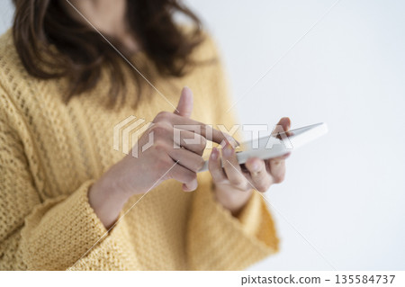 Woman using a smartphone Woman using a smartphone 135584737