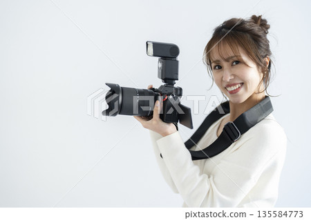 A woman with a digital camera 135584773