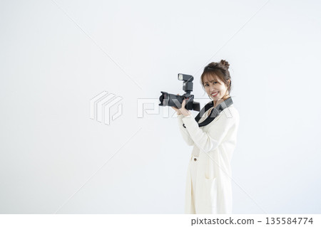 A woman with a digital camera A woman with a digital camera 135584774