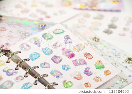 A sticker book filled with lots of stickers A sticker book filled with lots of stickers 135584993